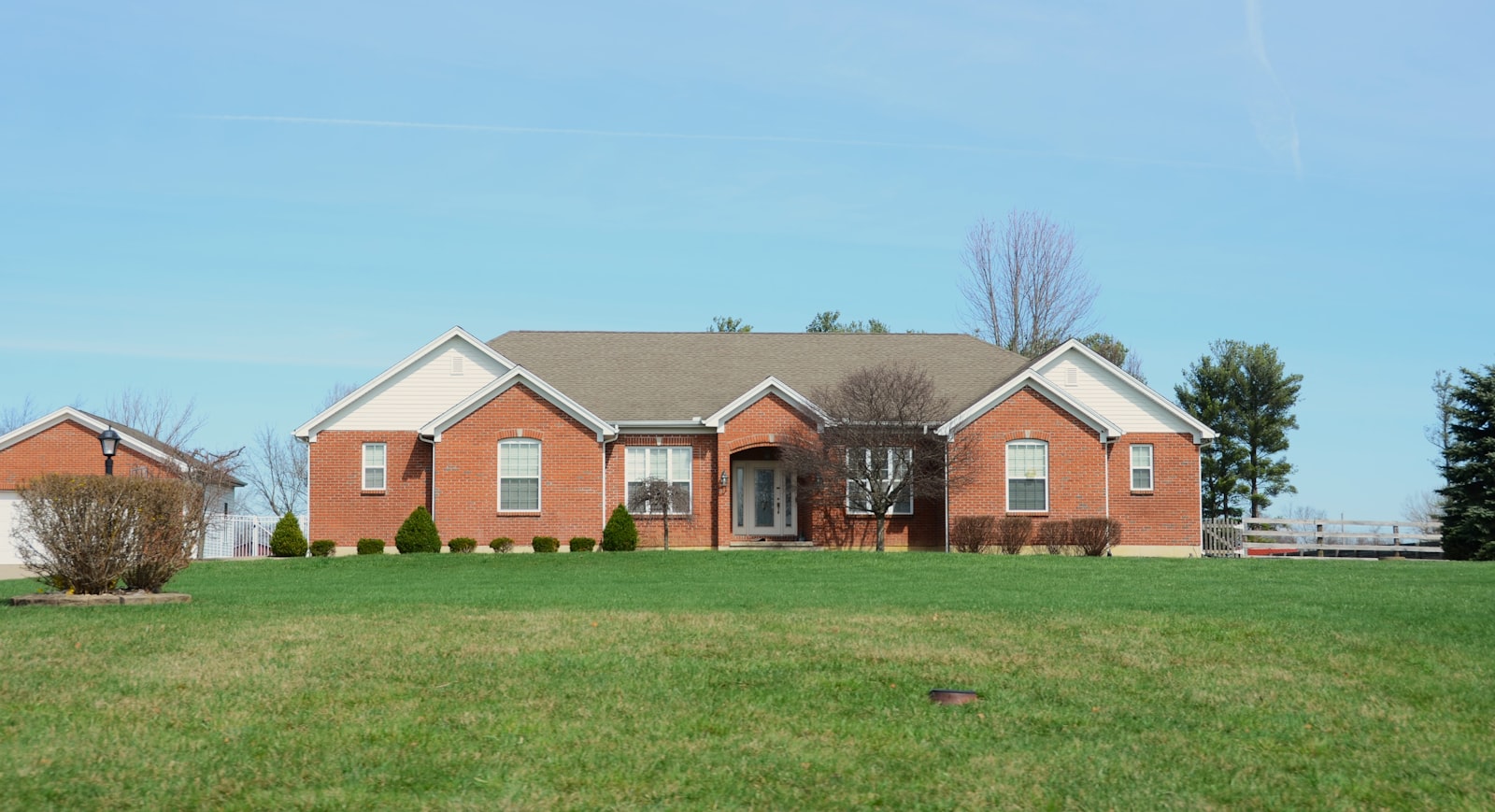 Brick Garland home with a freshly mowed front lawn and clean curb edge.